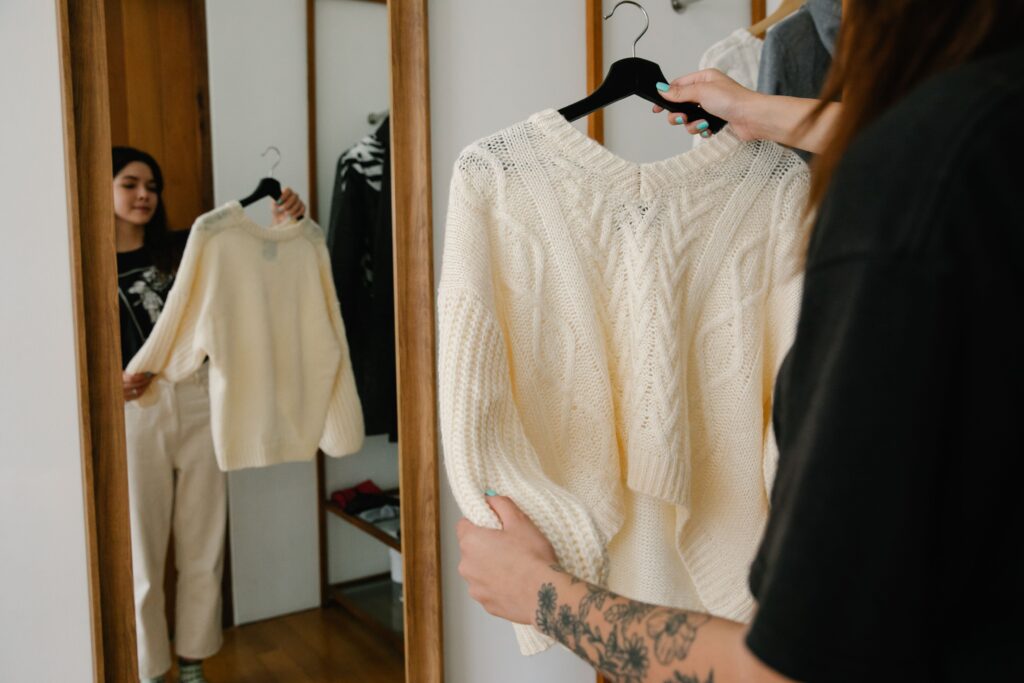 woman discovering personal style trying outfits in wardrobe aesthetic fashion blog cover”